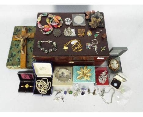 A wooden box containing a quantity of costume jewellery, a hallmarked silver hinged bangle with safety chain, various white m