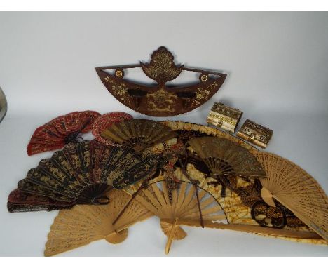A collection of hand fans, brass fan models, Asian hand puppet and other.
