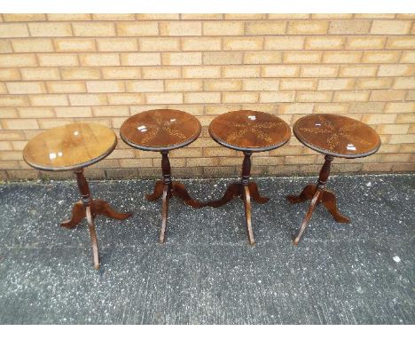 Four circular topped occasional or lamp tables on tripod supports, approximately 60 cm x 39 cm. [4]