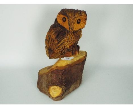 A carved wood owl, carved from large branch or tree trunk, approximately 45 cm (h).