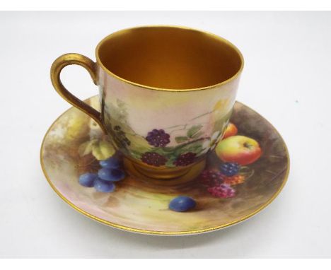 A Royal Worcester porcelain miniature demitasse cup and saucer decorated to the exterior with fruit and with gilt interior, t
