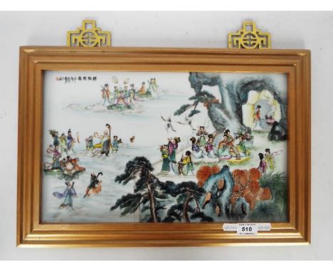 A framed ceramic tile / plaque decorated with numerous figures and auspicious symbols, signed, approximately 25 cm x 41 cm (n