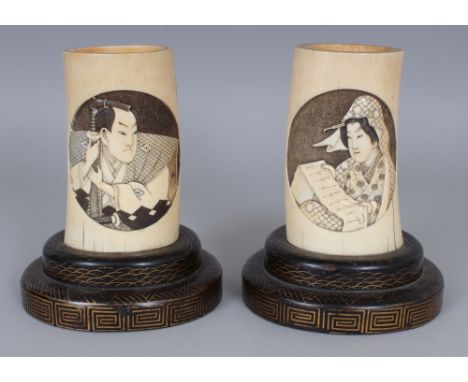 A GOOD PAIR OF JAPANESE MEIJI PERIOD IVORY TUSK VASES, together with fitted lacquered wood stands, each well carved with an o