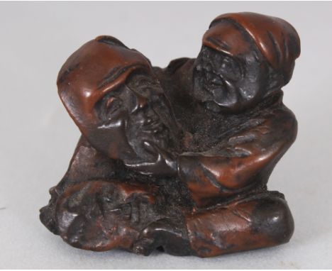 A SMALL JAPANESE CARVED WOOD NETSUKE OF A MASK MAKER, 1.25in wide & also 1.25in high.