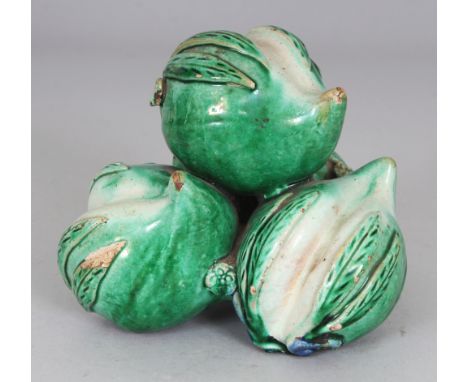 AN UNUSUAL CHINESE FAMILLE VERTE CERAMIC GROUP OF THREE PEACHES, possibly Kangxi period, applied with green and blue glazes, 
