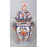 A GOOD EARLY 18TH CENTURY JAPANESE IMARI HEXAGONAL SECTION PORCELAIN VASE & COVER, unusually painted