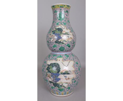 A 19TH CENTURY CHINESE PINK GROUND FAMILLE ROSE DOUBLE GOURD PORCELAIN VASE, painted with leaf-form river landscape panels re