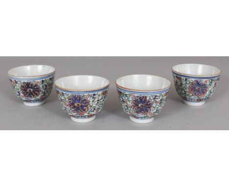 A GOOD GROUP OF FOUR CHINESE DAOGUANG PERIOD DOUCAI PORCELAIN TEA BOWLS, each painted with formal scrolling lotus, each base 