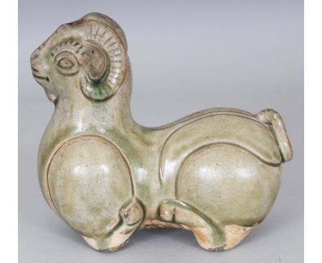 A CHINESE YUE WARE CELADON GLAZED CERAMIC MODEL OF A RAM, 5.6in long & 5in high.