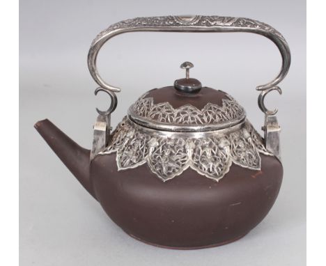 AN UNUSUAL 19TH CENTURY SILVER-METAL MOUNTED CHINESE YIXING POTTERY TEAPOT & COVER, with overhead swing handle, the Indonesia