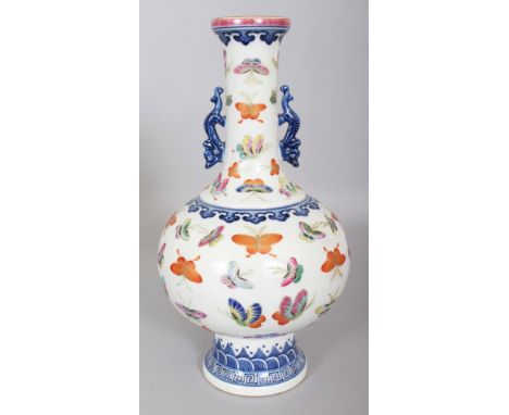 A CHINESE FAMILLE ROSE PORCELAIN BUTTERFLY DECORATED VASE, the base with a Qianlong seal mark, 11.4in high.