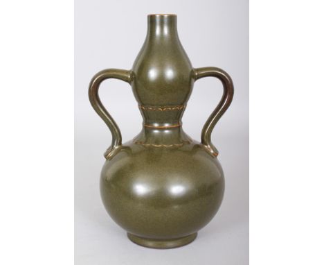 A CHINESE TEADUST GLAZED DOUBLE GOURD PORCELAIN VASE, with loop handles, the base with a Qianlong seal mark, 9in high.