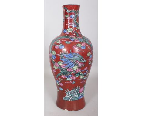 A RARE 18TH CENTURY CHINESE QIANLONG PERIOD FAMILLE ROSE LIVER RED GROUND PORCELAIN DRAGON VASE, the sides painted with a sin