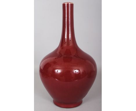 A CHINESE RED GLAZED PORCELAIN BOTTLE VASE, the unglazed base with a four-character slip glazed Yongzheng mark, 8.5in wide at