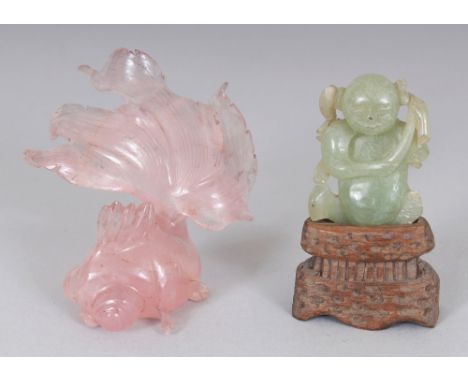 A CHINESE ROSE QUARTZ MODEL OF AN ANGEL FISH, 3.25in long; together with a small celadon jade figure of a boy on a fitted woo