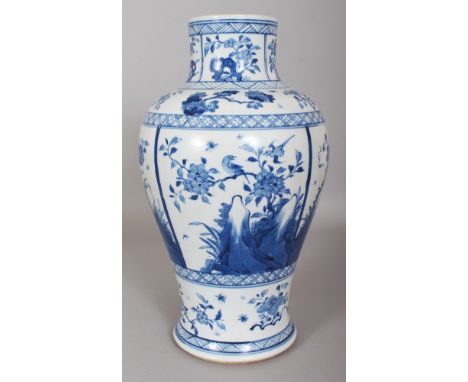 A CHINESE KANGXI STYLE BLUE & WHITE PORCELAIN VASE, decorated with panels of seasonal foliage, the base with an artemisia lea