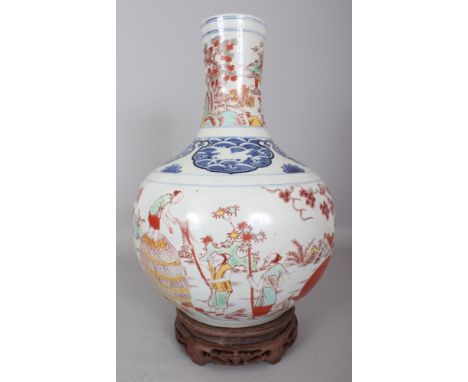 A LARGE CHINESE WANLI STYLE WUCAI PORCELAIN BOTTLE VASE, together with a wood stand, the sides unusually decorated with a sce