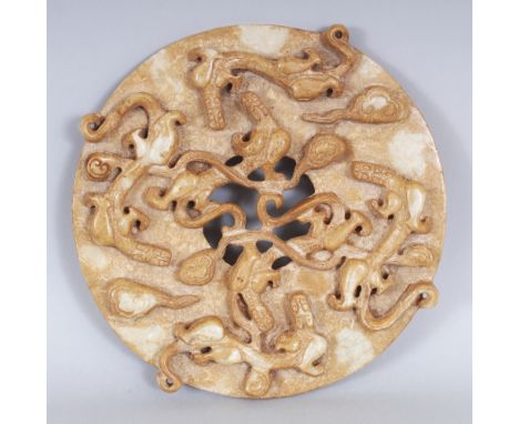 A CHINESE ARCHAIC JADE-LIKE HARDSTONE BI DISC, of larger than average size, one side decorated in high relief with sinuous ch