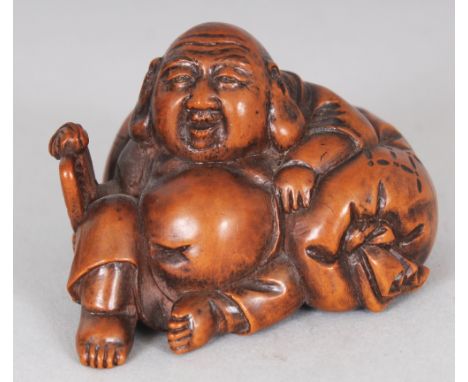 A JAPANESE MEIJI PERIOD CARVED WOOD NETSUKE OF HOTEI, reclining on his bag, 1.8in wide & 1.25in high.