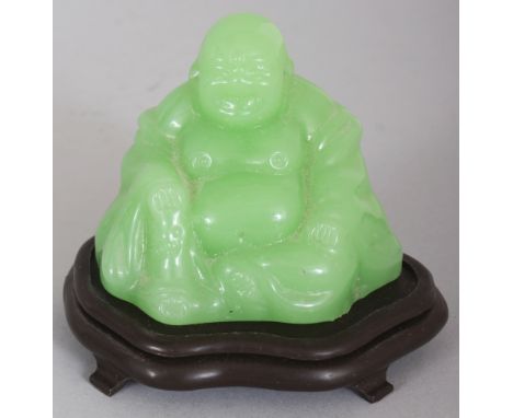 AN EARLY/MID 20TH CENTURY LIME GREEN GLASS MODEL OF BUDAI, together with a fitted wood stand, 2.75in high overall, the Budai 