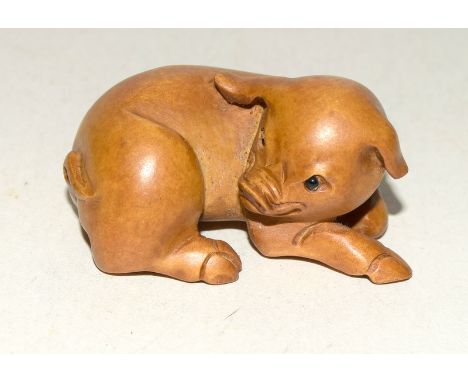 Wooden Japanese Netsuke in the form of a pig. Signed to the underside