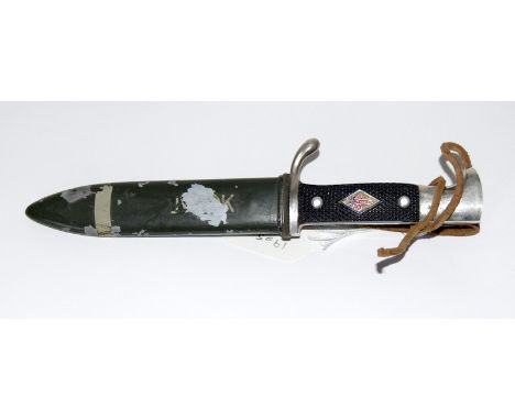 A vintage German Boy Scout knife in its steel scabbard