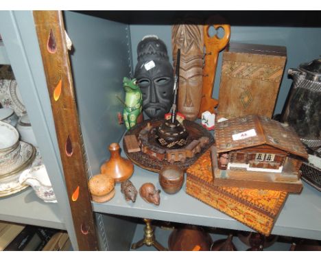 A selection of wood carved items including masks and trinket box