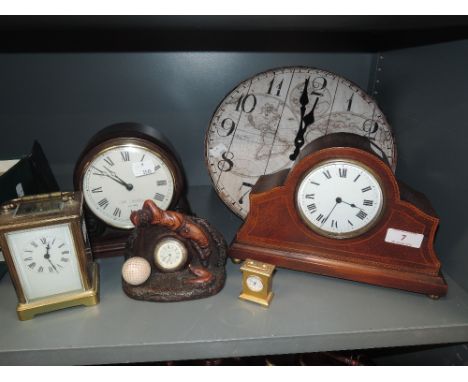 A selection of clocks with various designs including inlayed mantle clock brass bodied carriage clock and Widdop