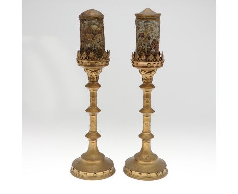 the knopped stems with stiff leaf and foliate decoration, topped with lead sconces and wax candles depicting religious figure