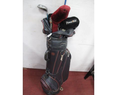 A Quantity of Golf Clubs in a Golf Bag, makers include, Dunlop, Arnold Palmer Powerpoint, Powerbilt (12)