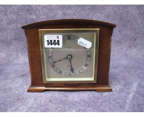 An Elliott Mahogany Mantel Clock, with a silver dial, Roman numerals on bracket feet, with retail name W.Allan, Ayr.