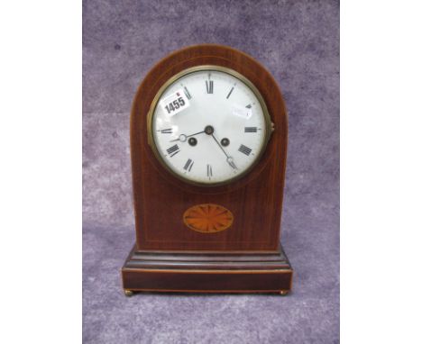 An Early XX Century Mahogany Inlaid Mantle Clock, with an enamel dial, Roman numerals, batwing marquatery inlay, on stepped b