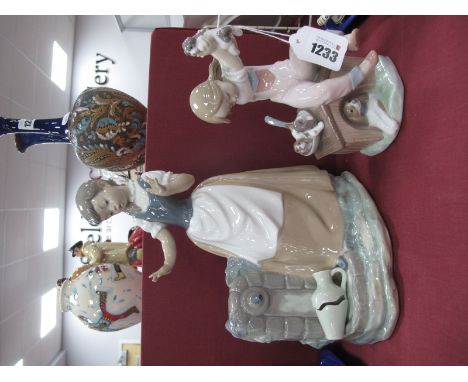 A Lladro Figure of Girl Holding Puppy Aloft 7621 B-5A, Nao figure of girl by broken vase. 