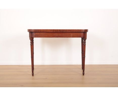 A REGENCY MAHOGANY CARD TABLE the hinged top opening to a green baize lined interior, on ring turned and tapered legs, 71cm h