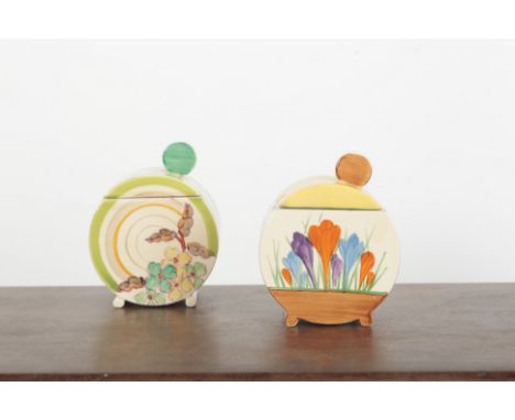 TWO CLARICE CLIFF BONJOUR PRESERVE POTS AND COVERS including a crocus pattern example, both 10.5cm high (2)