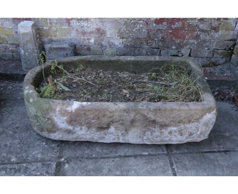 A LARGE STONE TROUGH 33cm high x 108cm long x 55cm wide