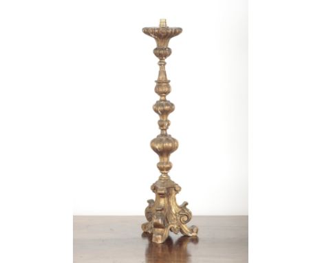 AN ITALIAN GILTWOOD ALTAR LAMP with ornately carved and moulded stem, on a tripod base, later fitted for electricity, 84cm hi