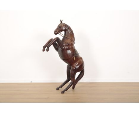 A LEATHER MODEL OF A REARING HORSE complete with saddle and reigns, 97cm high