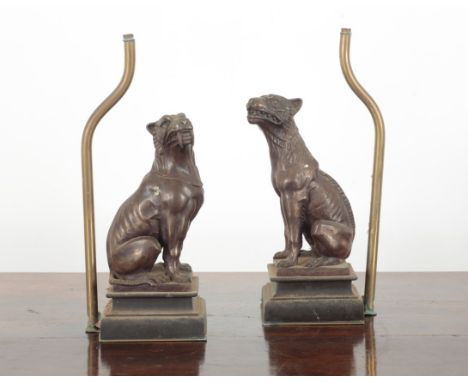 A PAIR OF PATINATED METAL TABLE LAMP BASES 20th century, each figured as seated hounds, on moulded plinth bases, numbered 32/