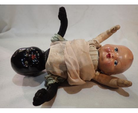 Vintage Tipsy Turvey black and white doll, both heads marked BAI, Made In England, hard plastic, joining body and arms, stuff
