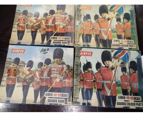 Four Airfix HO/OO scale figure sets, two guards band and two guards colour party, appear complete, unchecked, wear to boxes. 