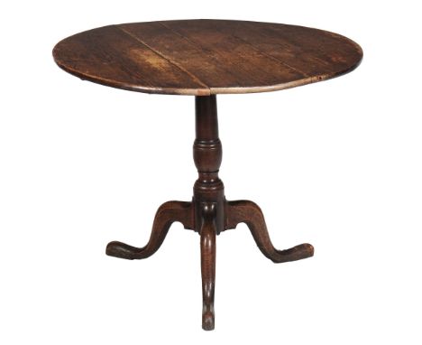  A George III oak tripod table,   the circular tilt top on turned stem with splayed legs and pad feet 66cm high, 88cm diamete