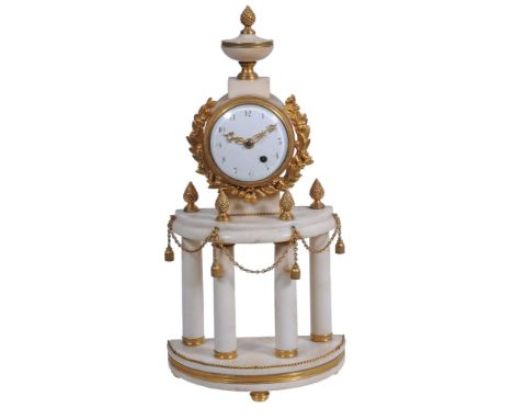 A Louis XVI style gilt brass and white marble mantel timepiece, unsigned, early 19th century,   the circular three pillar si
