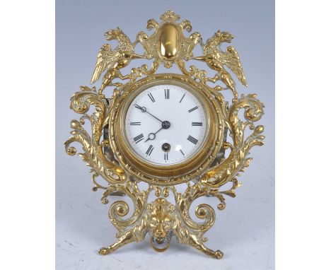 A Victorian brass strut clock, having an unsigned circular white enamel Roman dial, single winding hole for an eight day bras