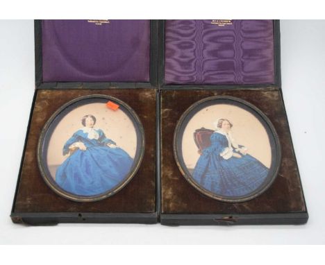A pair of early 20th century overpainted portrait photographs, each 18 x 14cm 