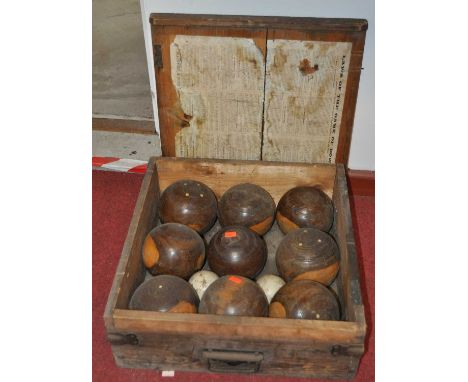 A box containing a set of vintage lignum vitae bowls