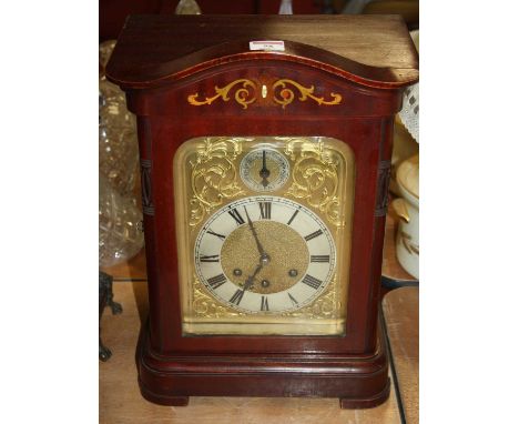 A 20th century mahogany cased eight-day mantel clock, the silvered chapter showing Roman numerals and signed G W Wilson Bury 