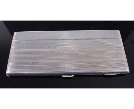 A 20th century American white metal pocket cigarette case, of rectangular form having engine turned decoration, the cartouche