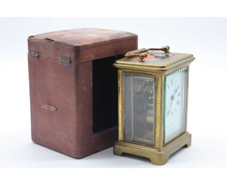 A French brass cased carriage clock, the enamelled dial showing Roman numerals and signed Elkington &amp; Co, the movement ha