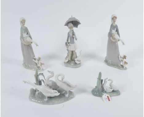 A Lladro porcelain model of geese; together with three other Lladro porcelain groups; and a Nao group, the largest h.27.5cm 